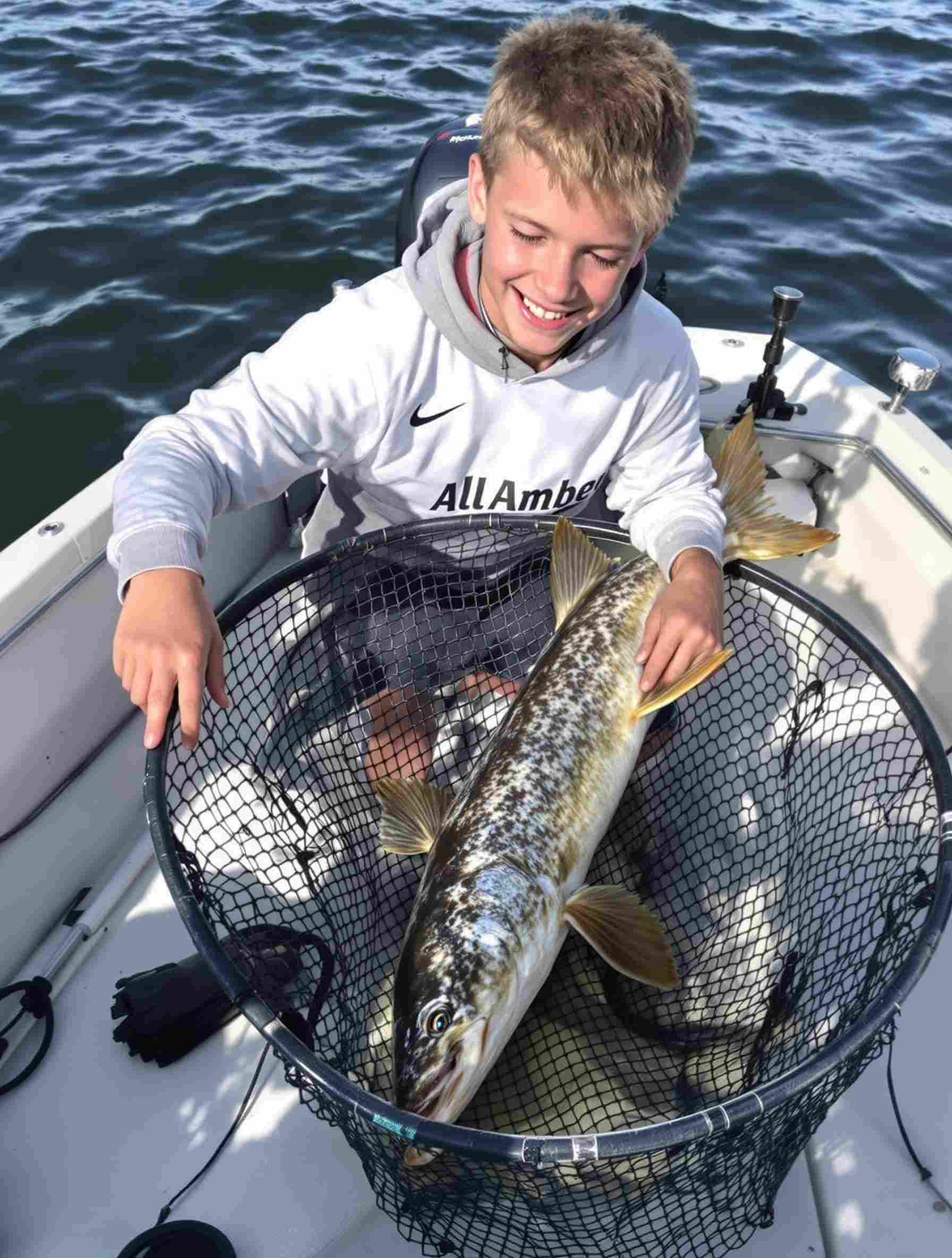 Guide helping land a pike